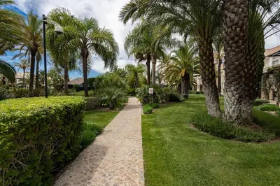 a walking path in a park with palm trees at Palmyra by Intiholidays in Vilamoura