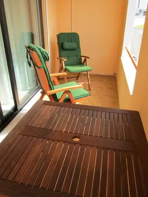two chairs and a table in a room at Quarteira Paul Harris Apartment in Quarteira