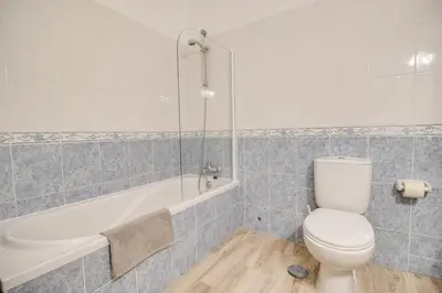 a bathroom with a toilet and a bath tub at Welcoming Oasis 500m Beach AC Wi-Fi Pool Balcony in Albufeira