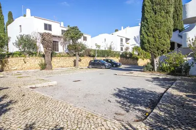 a car parked in a parking lot next to a house at Welcoming Oasis 500m Beach AC Wi-Fi Pool Balcony in Albufeira