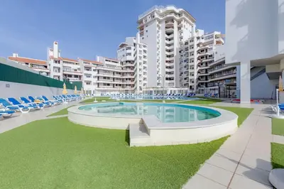 a large swimming pool in the middle of a building at VILA MAGNA - Apart renovado para 4 com piscina e Ar condicionado in Albufeira