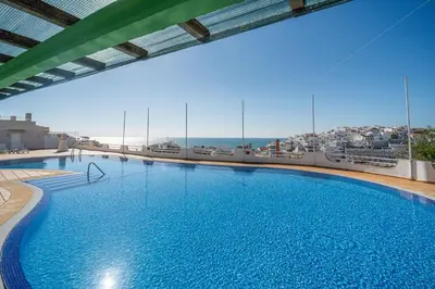 a large swimming pool on top of a building at Colibri by HelloVacations in Albufeira
