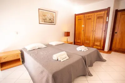 a bedroom with a bed with two towels on it at Colibri by HelloVacations in Albufeira