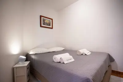 a bedroom with a bed with two towels on it at Colibri by HelloVacations in Albufeira