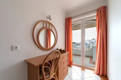 a room with a table and a mirror and a window at Colibri by HelloVacations in Albufeira