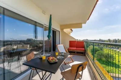 a balcony with a table with a bowl of fruit on it at Tasteful 1 BDR Flat W/Balcony & Pool by LovelyStay in Quarteira