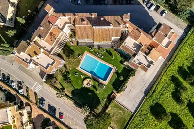 an overhead view of a house with a pool at Tasteful 1 BDR Flat W/Balcony & Pool by LovelyStay in Quarteira