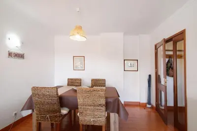a dining room with a table and chairs at Tenis Golfmar in Vilamoura