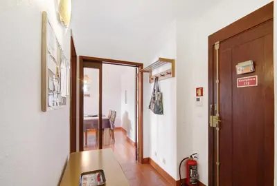 a hallway with a door and a room with a table at Tenis Golfmar in Vilamoura