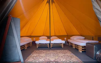 a room with three beds in a tent at Glamping Camp Faro in Faro