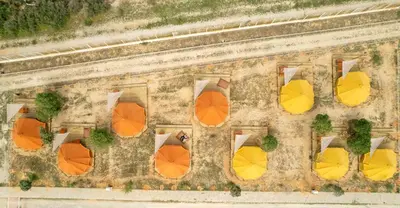 an overhead view of a patio with colorful umbrellas at Glamping Camp Faro in Faro