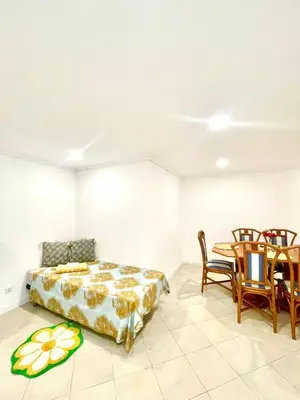 a bedroom with a bed and a table and chairs at Flat Luxuoso Praia da Oura in Albufeira