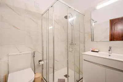 a bathroom with a shower and a toilet and a sink at Vila Amélia by Sunnyway in Albufeira