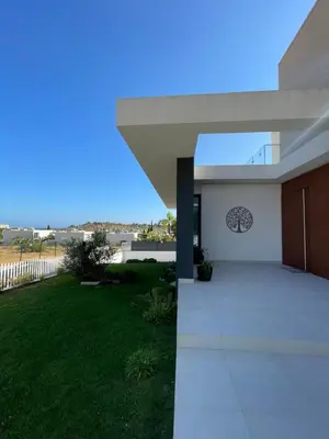 a view of a modern house with a yard at Casa Papoila in Albufeira