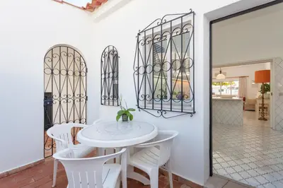 a living room with a couch and a fireplace at Villa Rosa in Vale do Lobo