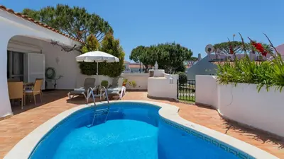 a white house with a green yard at Villa Rosa in Vale do Lobo