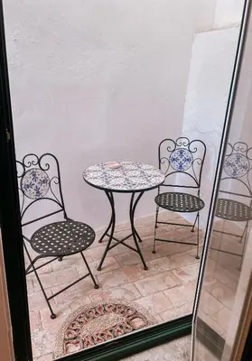 a table and two chairs and a table and chairs at Grand Studio 54 in Faro