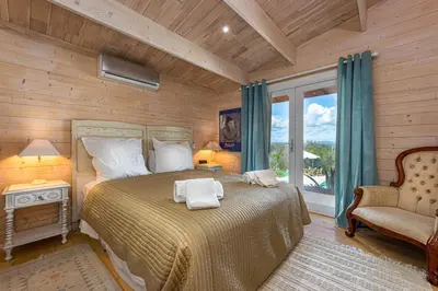 a bedroom with a bed and a chair and a window at Design Chalet in Albufeira With Private Pool in Albufeira