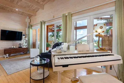 a living room with a white piano in a room at Design Chalet in Albufeira With Private Pool in Albufeira