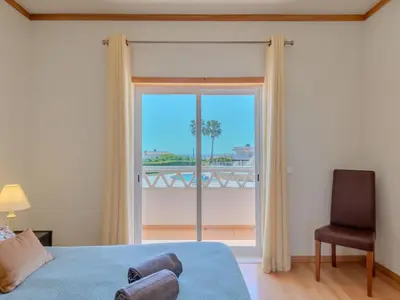 a bedroom with a bed with two towels on it at Holiday Home Cerro Aguia AM V2 - VIP Properties by Interhome in Albufeira