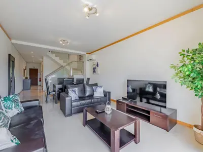 a kitchen with wooden cabinets and a dishwasher at Holiday Home Cerro Aguia AM V2 - VIP Properties by Interhome in Albufeira