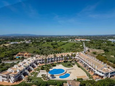 a large swimming pool with blue water at Holiday Home Cerro Aguia AM V2 - VIP Properties by Interhome in Albufeira