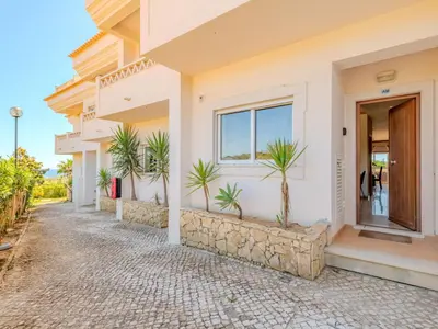 a living room with a couch and a television at Holiday Home Cerro Aguia AM V2 - VIP Properties by Interhome in Albufeira