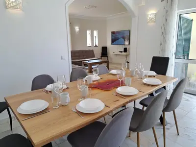 a kitchen with white cabinets and stainless steel appliances at Villa Monteiro V4 - VIP Properties by Interhome in Albufeira