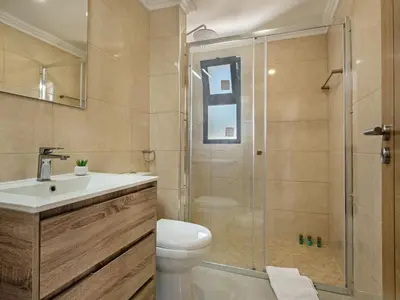 a bathroom with a shower and a toilet and a sink at Villa Corcovada V4 VIP Properties by Interhome in Albufeira
