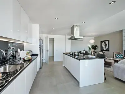a dining room and living room with a table and chairs at Villa Sónia Lote 69 - VIP Properties by Interhome in Albufeira