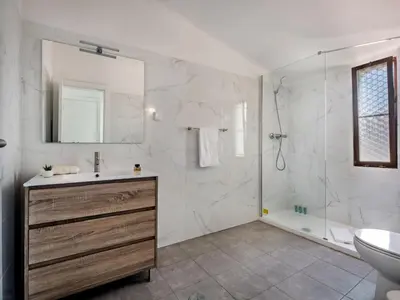 a white bathroom with a sink and a shower at Villa Jenny - VIP Properties by Interhome in Albufeira
