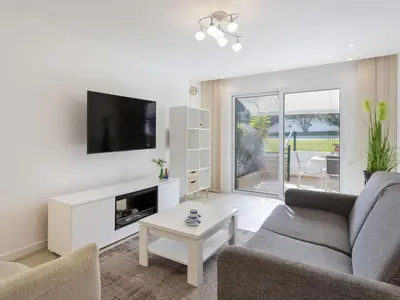 a kitchen with white cabinets and a stainless steel refrigerator at Holiday Home Pierre by Interhome in Galé