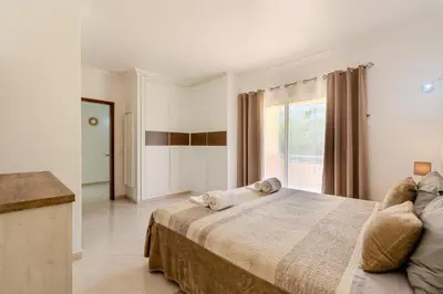 a living room with a couch and a chandelier at Villa Orange with private pool Albufeira in Albufeira