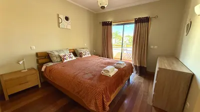 a living room with leather furniture and a staircase at Villa Paula with Private Pool Close to the Beach and Strip in Albufeira