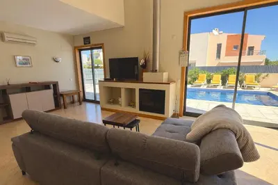 a living room with two couches and a tv at Villa Paula with Private Pool Close to the Beach and Strip in Albufeira