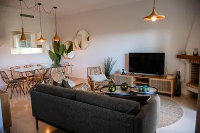 a living room with a couch and a table at Quinta do Lago Golfside Retreat in Quinta do Lago