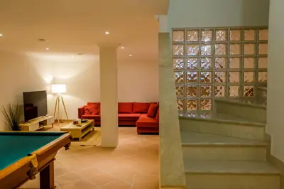 a living room with a pool table at Quinta do Lago Golfside Retreat in Quinta do Lago