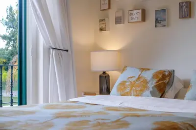 a bedroom with a bed and a window at Quinta do Lago Golfside Retreat in Quinta do Lago