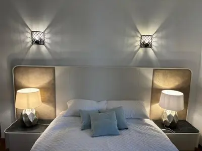 a bedroom with two lights on top of a bed at Villa GALVANA in Guia