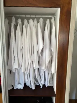 a closet with white clothes hanging in it at Villa GALVANA in Guia