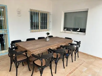 a large wooden table and chairs in a room at Villa GALVANA in Guia