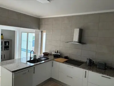 a kitchen with white cabinets and a counter top at Villa GALVANA in Guia