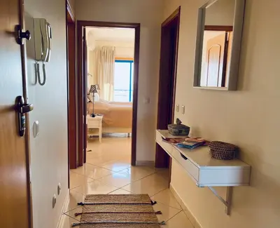 a bathroom with a sink and a mirror at Pérola do Algarve in Quarteira