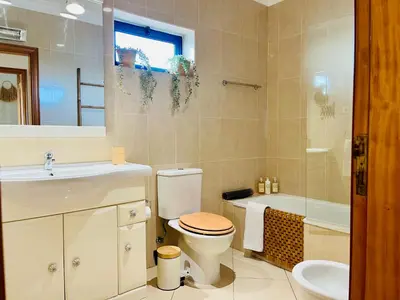 a bathroom with a toilet and a sink and a tub at Pérola do Algarve in Quarteira