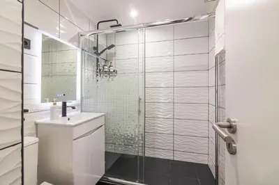 a bathroom with a shower and a toilet and a sink at Flat with Pool T2 Duplex Montechoro in Albufeira