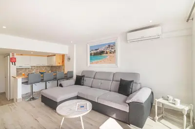 a living room with a couch and a table at Flat with Pool T2 Duplex Montechoro in Albufeira