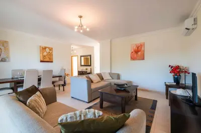 a living room with a couch and a table at Balaia Residense Penthouse 2 Bedroom Apartment with Pool in Albufeira