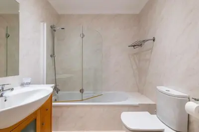 a bathroom with a shower and a toilet and a sink at Balaia Residense Penthouse 2 Bedroom Apartment with Pool in Albufeira