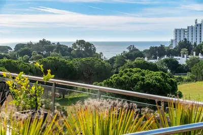 a view of the ocean from the balcony of a building at Balaia Residense Penthouse 2 Bedroom Apartment with Pool in Albufeira