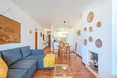 a living room with a blue couch and a fireplace at Apartamento Ivone by Sunnyway in Albufeira